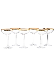 A Set of Six Crystal Coupe Glasses with Gilded Rims